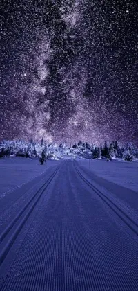 This live wallpaper depicts a snowy field with clearly defined tracks, surrounded by a stunning starry sky