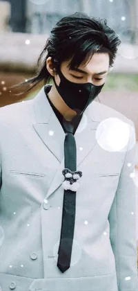 This phone live wallpaper features a handsomely dressed man sporting a face mask