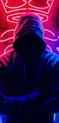 Adorn your phone screen with a digital art live wallpaper featuring a mysterious figure in a hoodie standing before a glowing neon sign