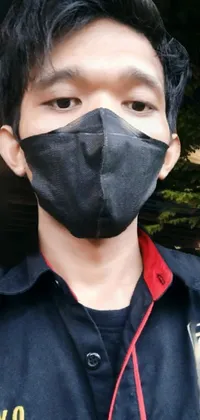 This phone live wallpaper features a close-up shot of someone wearing a face mask