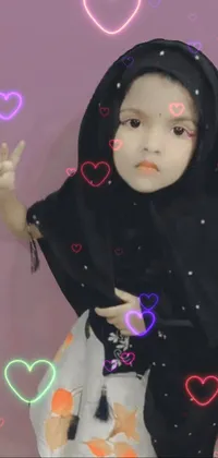 This phone live wallpaper showcases an image of a doll of a little girl adorned in a hijab, surrounded by a peace sign