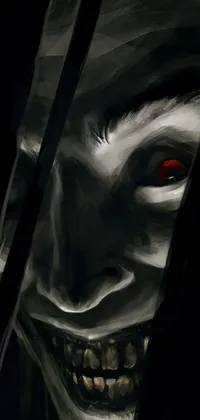 This phone live wallpaper features a close-up of a creepy face with pointed teeth and glowing eyes against a dark and eerie background