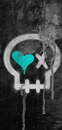 This phone live wallpaper features a striking black and teal graffiti-style skull with a heart