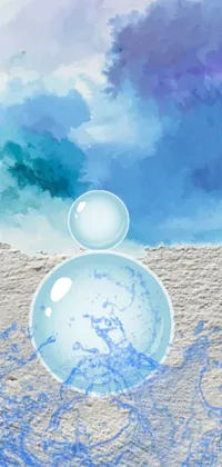 This phone live wallpaper features two bubbles on a sandy beach surrounded by lush scenery