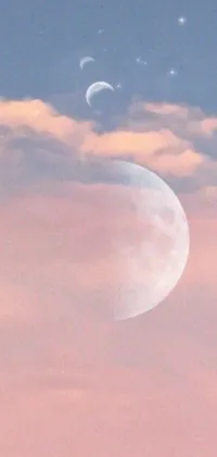 This live wallpaper features a captivating digital art depiction of two moons in the sky with a fantasy aesthetic