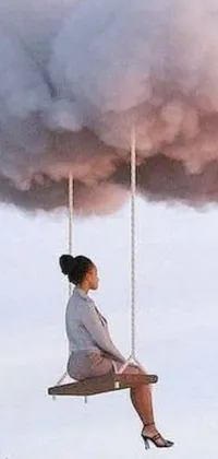 This phone live wallpaper depicts a woman on a swing suspended from a cloud amidst a cityscape lost in a toxic haze