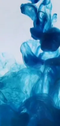 Looking for an eye-catching phone wallpaper? Check out this mesmerizing close-up of blue ink in water