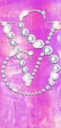 This is an exquisite phone live wallpaper featuring a close-up of a necklace on a purple digital background
