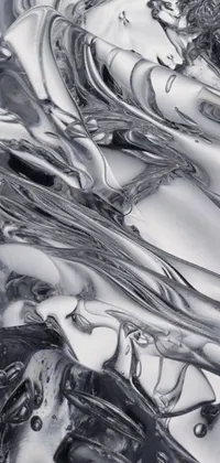 This phone live wallpaper presents a black and white, hyperrealistic photograph of liquid