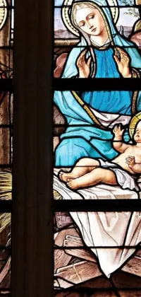 This live wallpaper showcases a stunning stained glass window of a nativity scene depicted in beautiful colors and intricate designs