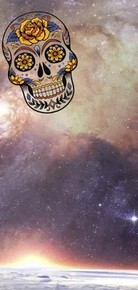 This phone live wallpaper features a beautifully designed sugar skull against a deep blue sky backdrop, complemented by the shimmering Milky Way and other distant galaxies