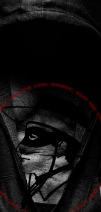 This live wallpaper showcases a rebellious attitude through a black and white image of a man wearing a hoodie and bandit mask with a red star emblem