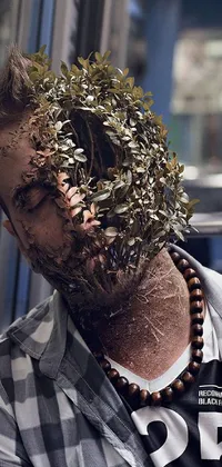 Get a mesmerizing phone live wallpaper! The image showcases a man with a plant growing out of him