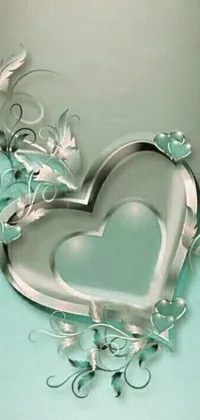 Feast your eyes on this stunning mobile wallpaper featuring a heart-shaped mirror surrounded by delicate and intricate vines in shades of tiffany blue and silver