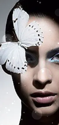 This live wallpaper for your phone displays an ethereal image of a woman with a butterfly on her head