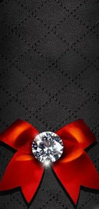 Add a touch of elegance to your mobile device with this exquisite red ribbon and diamond phone live wallpaper
