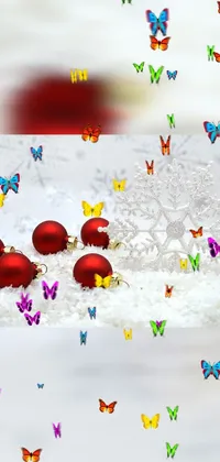 Looking for an adorable and festive live wallpaper for your phone? Look no further than this high definition screenshot of christmas ornaments sitting on top of a snow covered ground! The cute and colorful design, created by a talented artist, adds a touch of holiday cheer to your phone's home screen
