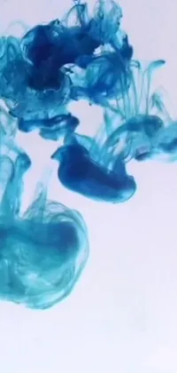 This live wallpaper showcases a close-up of blue ink mixing in water, which creates a beautiful microscopic pattern