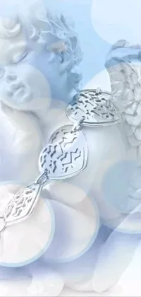 This phone live wallpaper features two angel figurines in silver bracelets against a soft gradient of pale blue and purple