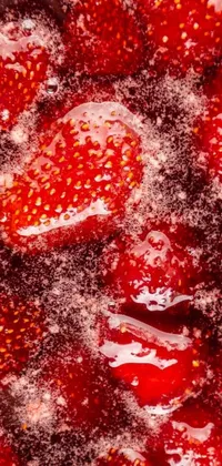 This phone live wallpaper features a close up of a bunch of strawberries, photographed with macro precision