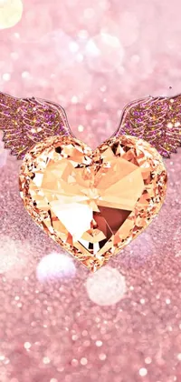 This phone live wallpaper displays a glittery background adorned with a heart and wings in digital rendering, embellished with diamonds and rose quartz for an elegant touch