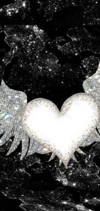 This phone live wallpaper features a stunning white heart with wings, covered in sparkling crystals and glitter on a black background
