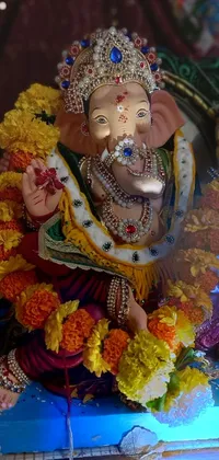 This phone live wallpaper showcases a stunning close-up of a beautifully decorated elephant statue adorned with vibrant flowers in an Instagram-like aesthetic