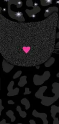 This live phone wallpaper features a bold black cat holding a bright pink heart in its mouth