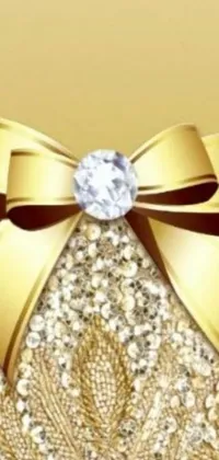 This <a href="/color-wallpapers/gold-wallpapers">live gold wallpaper</a> showcases a shimmering bow and diamond centered on a tasteful background