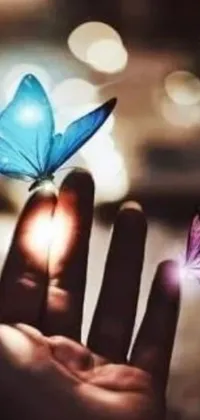 Elevate your phone's look with this stunning live wallpaper of a hand holding a butterfly