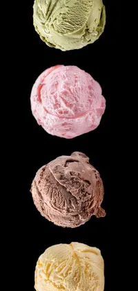 This phone live wallpaper features three scoops of ice cream set against a black background by an artist