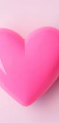 This live phone wallpaper features a pink heart in a dreamy style