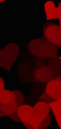 This live phone wallpaper showcases a striking image of red hearts set against a black background