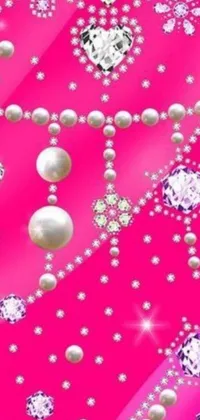 This phone live wallpaper features an elegant pink background adorned with radiant pearls and diamonds