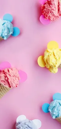 This live wallpaper for your phone features a group of colorful ice cream cones on a pink surface