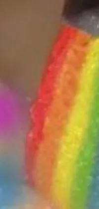 This live phone wallpaper features a close-up of a face with a colorful rainbow painted on it