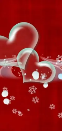 This phone live wallpaper features two hearts bordered by falling snowflakes on a passionate red background
