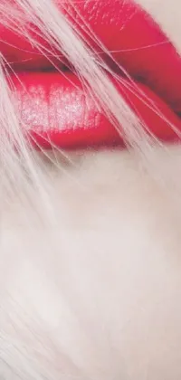 This phone live wallpaper features a close-up of painted lips in red, set against a dark background and layered with contrasting shades of light