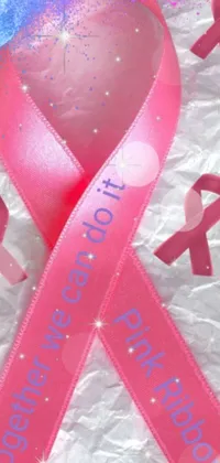 This live wallpaper for your phone showcases a pink ribbon with the words "breast cancer" along with a beautiful picture