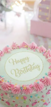 This phone live wallpaper depicts a stunning birthday cake in soft pink colors atop a table, captured in a close-up view