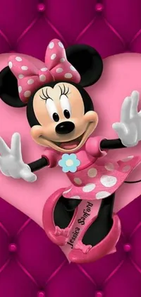 Looking for a fun and adorable wallpaper for your phone? Look no further than this Minnie Mouse live wallpaper! Featuring a cute pink heart backdrop with a photo in the center, this wallpaper depicts Disney's lovable Minnie waving and smiling at you