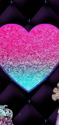 This live wallpaper features a sparkling pink and blue heart with jewel accents surrounded by a Lisa Frank inspired mosaic