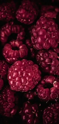 This phone live wallpaper showcases a beautiful digital art piece featuring a pile of delectable raspberries displayed on a table