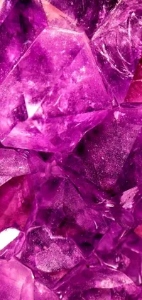 This phone live wallpaper features a stunning macro photograph of a pile of purple crystals arranged in a cubist style on top of a table
