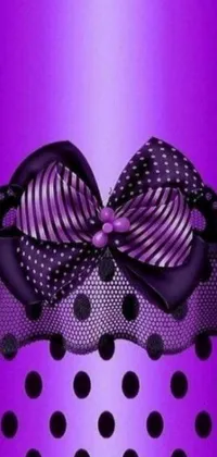 This live phone wallpaper features a charming purple and black polka dot backdrop with a playful bow center-piece