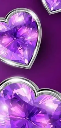 This phone live wallpaper showcases three purple hearts made of crystals and diamonds on a purple background
