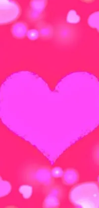 This live wallpaper for phone features a close-up shot of a glowing heart on a pink background