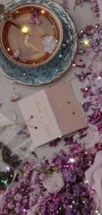 This enchanting live wallpaper depicts a delicate tea cup resting on a charming flower-adorned table