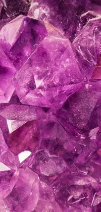 This live wallpaper features a stunning pile of purple crystals on a table