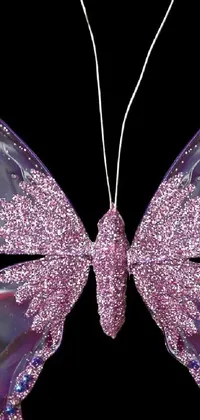 This phone live wallpaper features a butterfly ornament with intricate details on the wings and body